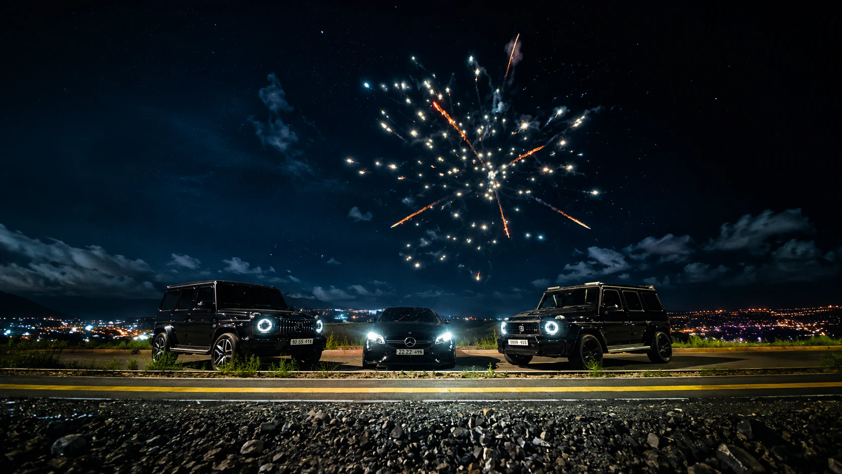 Three Mercedes-Benz vehicles beneath fireworks above Ulaanbaatar